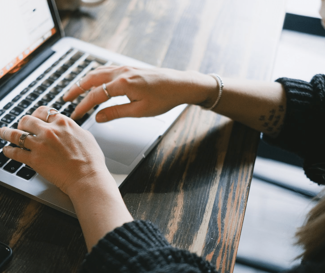 A person typing on a laptop