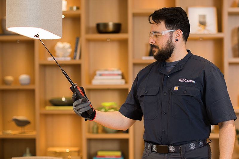 on demand facility technician providing mobile service on a light fixture 