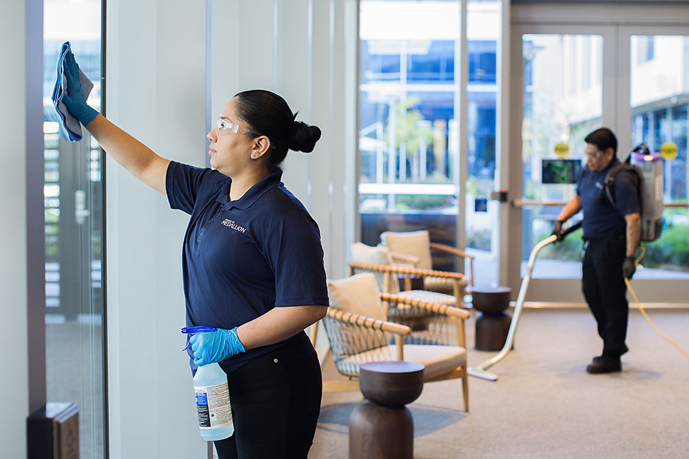 Janitorial staff deep cleaning a corporate campus lobby