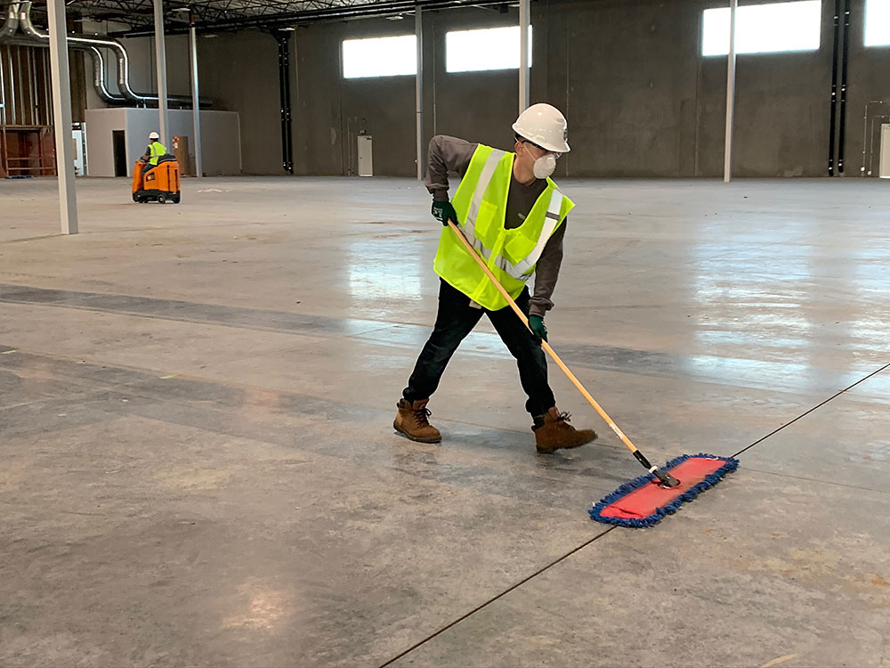 Construction clean up professional dusting concrete floors