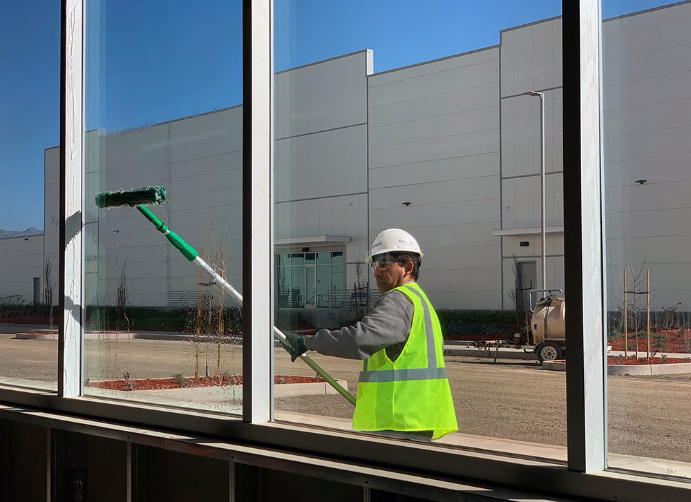 Construction cleaning professional cleaning windows with a squeegee 