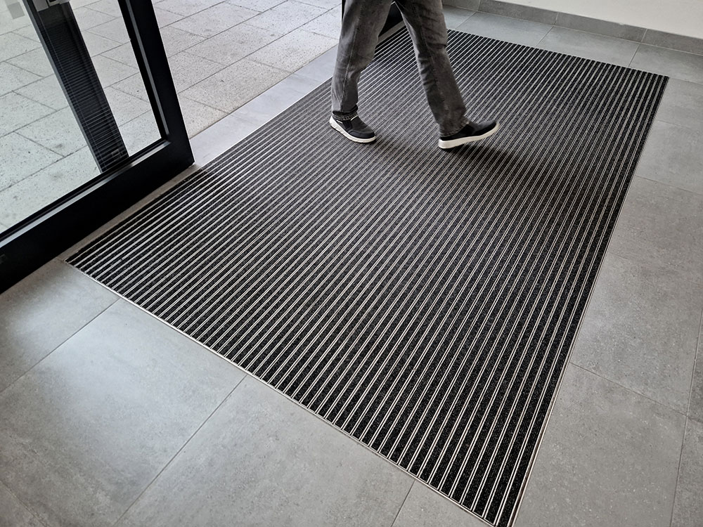 Person walking on a floor mat in a reception area