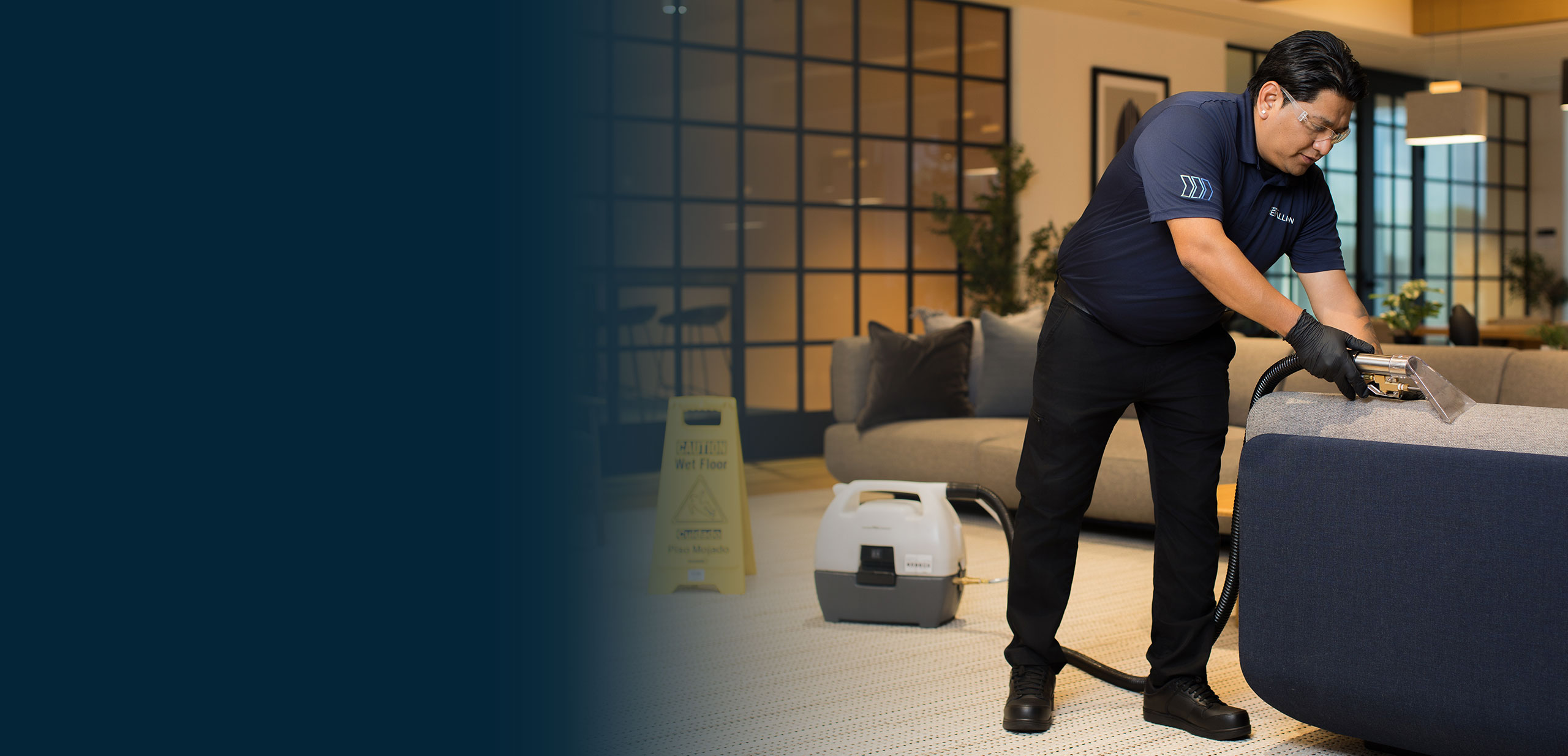 Specialty Cleaning Services technician using upholstery extraction equipment to deep clean upholstered seating in a commercial workplace