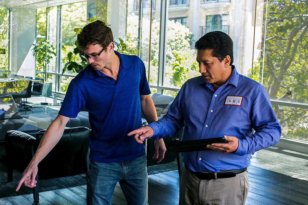 Facility services professional reviewing building conditions with a client during a workplace walkthrough