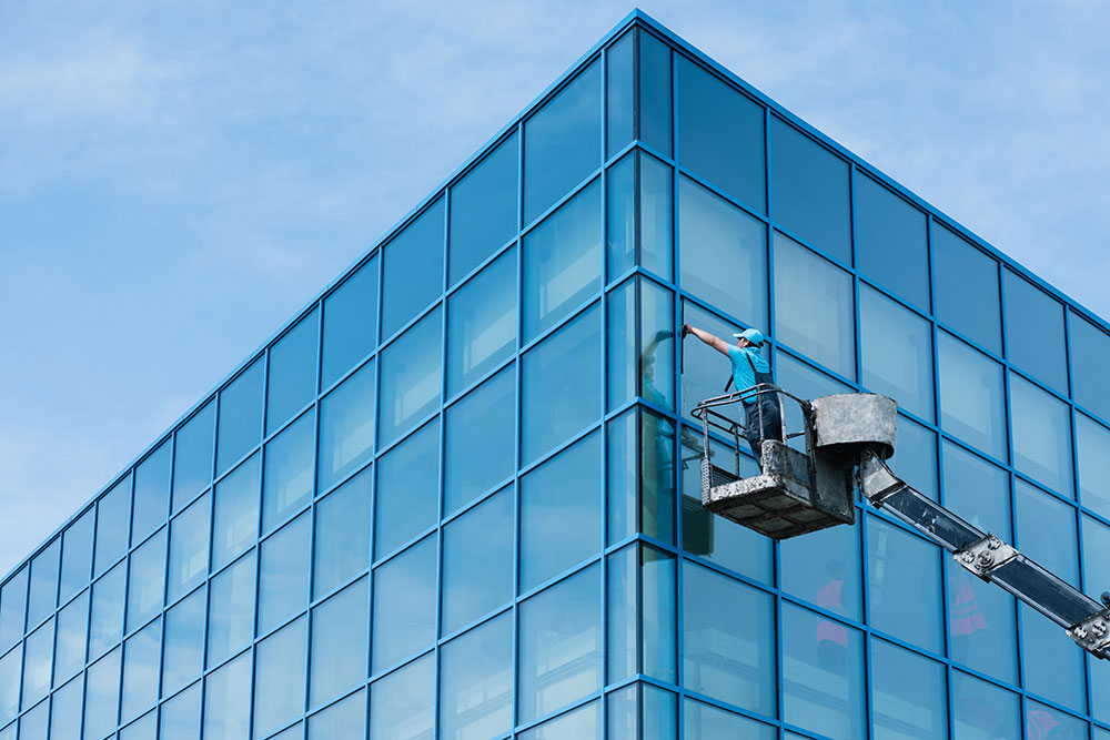 Professional commerical window cleaning on a lift cleaning exterior windows