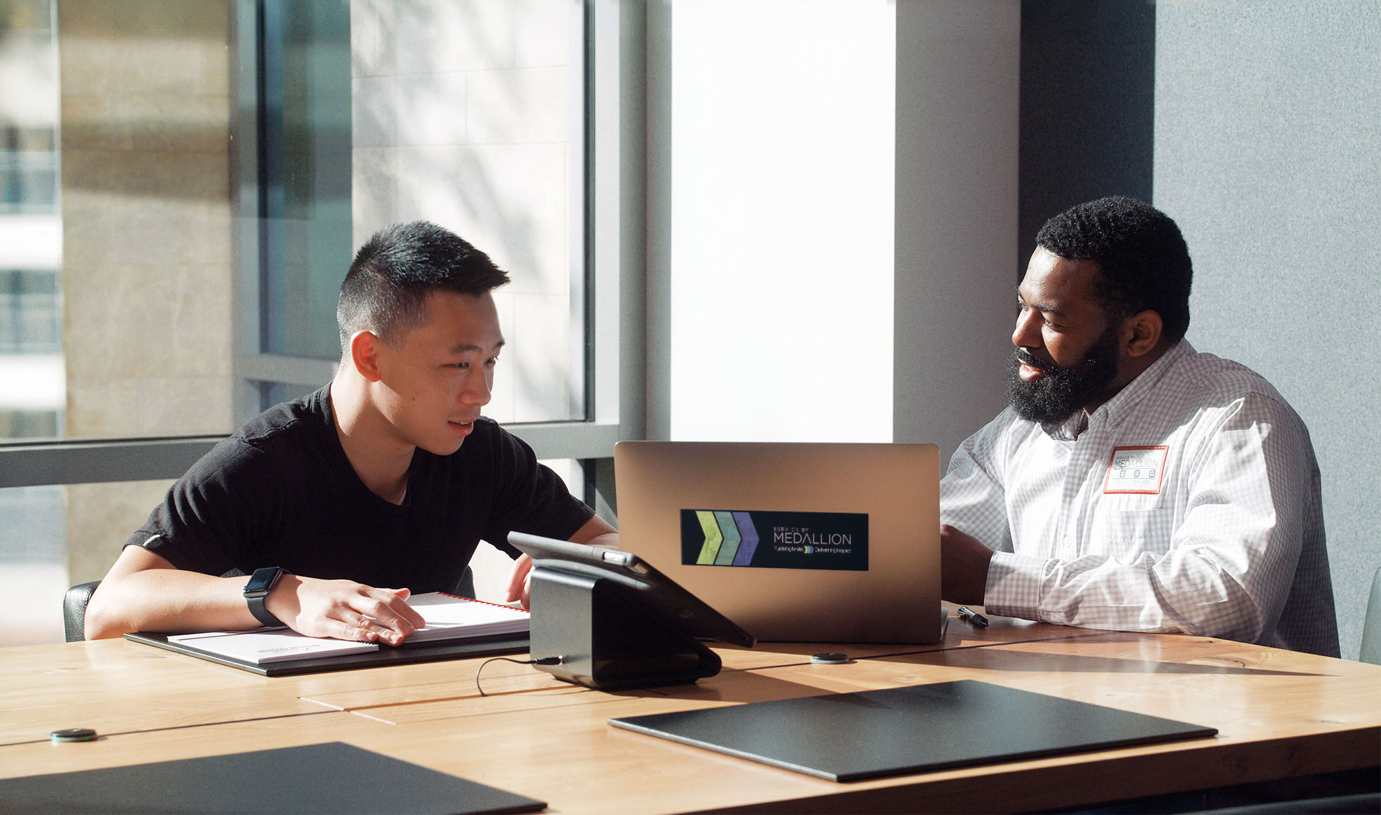 Service team member meeting with a client to review facility operations and discuss service performance