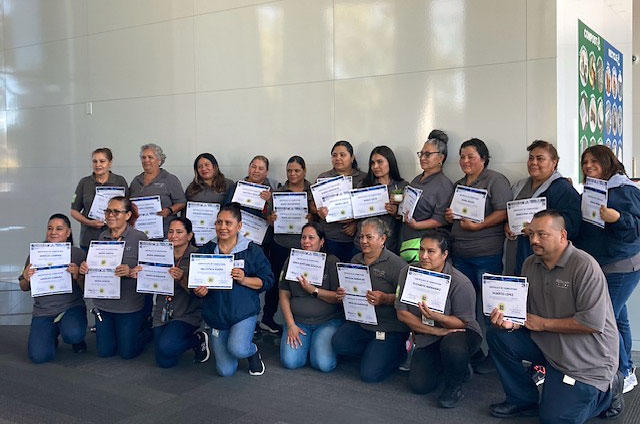 Service by Medallion building maintenance team receiving recognition for completing an english course